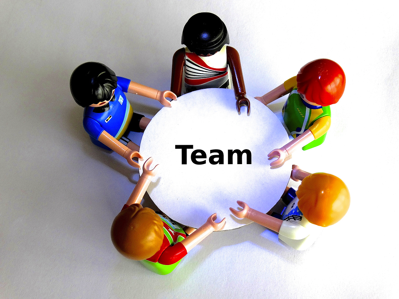 A group working together over a shared game board