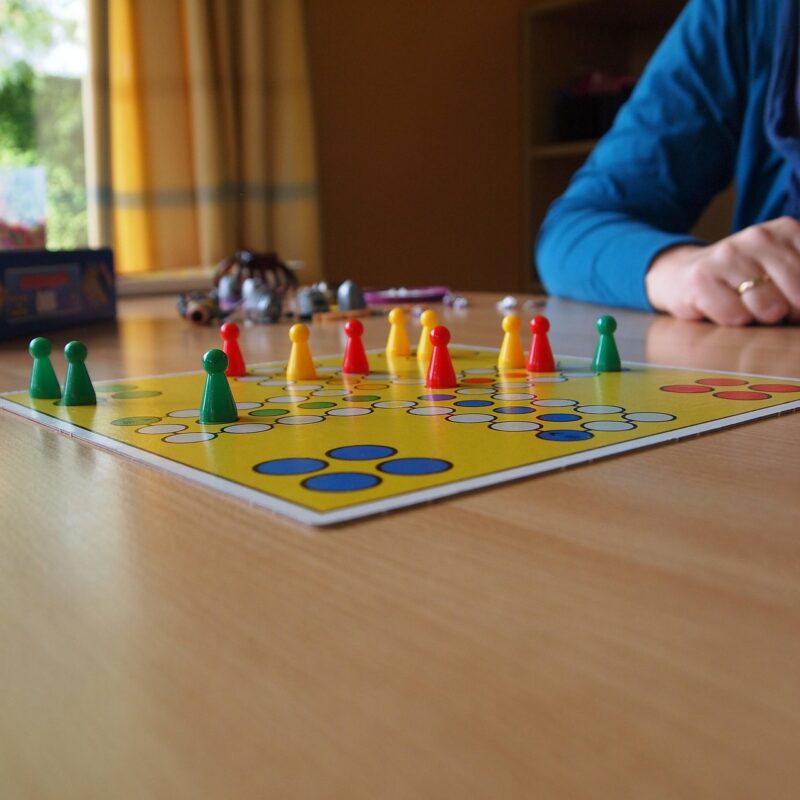 A short card game being played at a kitchen table